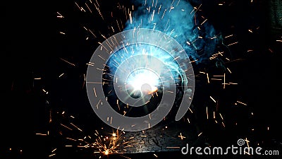 Welder welds a metal part, a lot of sparks and smoke, close-up, welding, close-up, background stock video footage